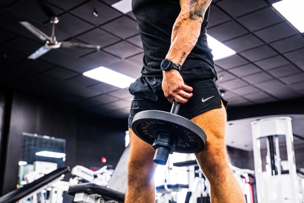 Athlete performing wrist curl with I-Bell on bench