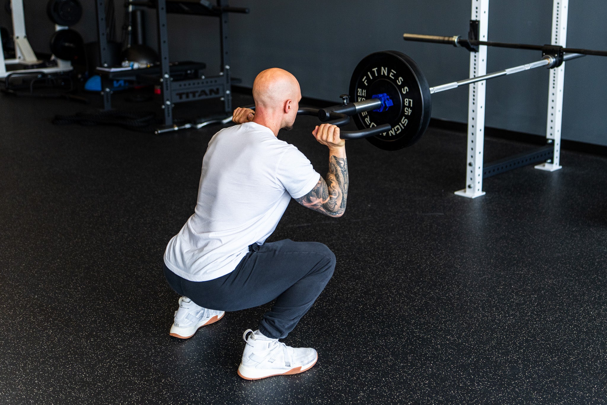 A lifter training with the Viking Press in a squat position